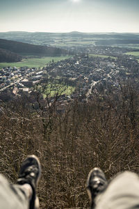 Low section of person on landscape against sky