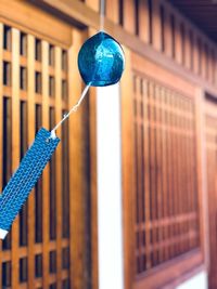 Close-up of blue metal fence against building