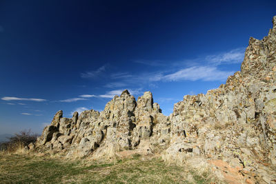 Low angle view of rock formations against sky