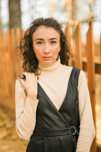 Portrait of young woman standing outdoors