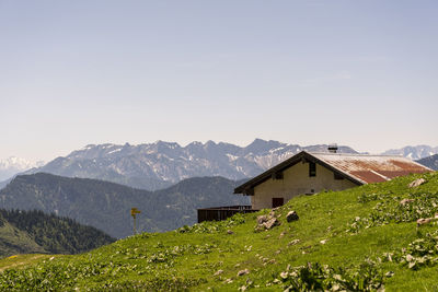 Houses by mountain against sky