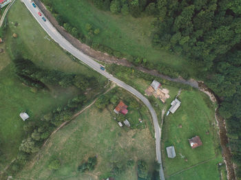 High angle view of road amidst trees on field