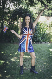 Beautiful woman wearing and holding the union jack flag