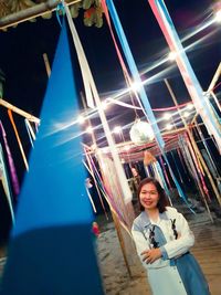 Portrait of smiling young woman standing on playground