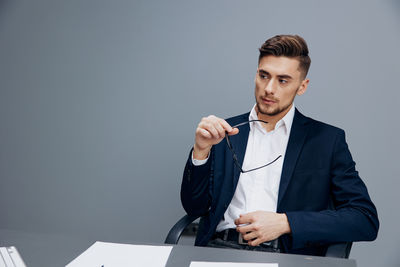 Portrait of young businesswoman working at desk in office