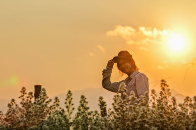 Man photographing against sky during sunset