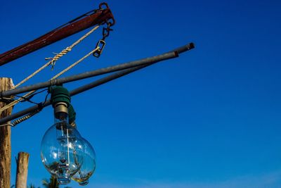 Low angle view of metallic structure against blue sky