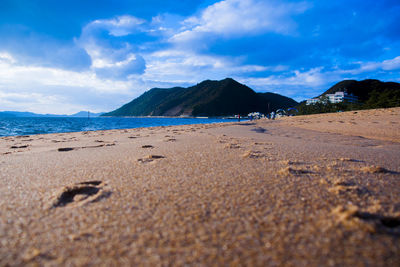 Scenic view of beach against blue sky