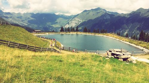 Scenic view of lake and mountains against sky