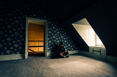 Man sitting by window at home