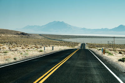 Rear view of person on road against clear sky