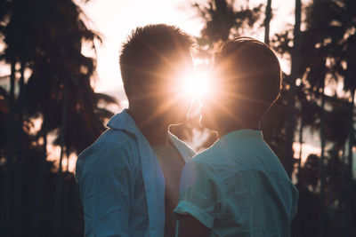 Portrait of couple with people in sunlight