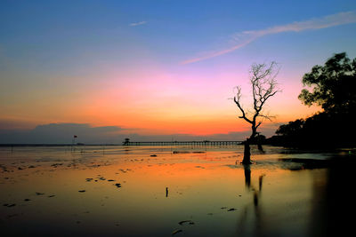 Scenic view of lake against orange sky