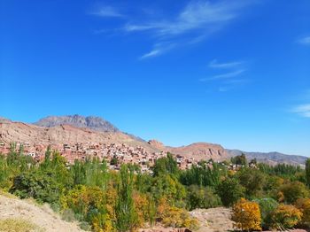 Scenic view of landscape against blue sky