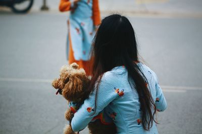 Rear view of woman with dog walking