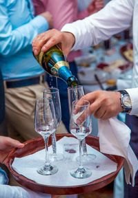 Close-up of cropped hand holding glass