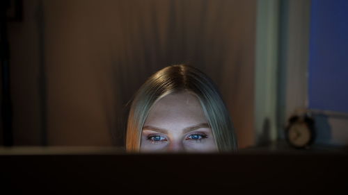 Beautiful woman looking at laptop while sitting at home