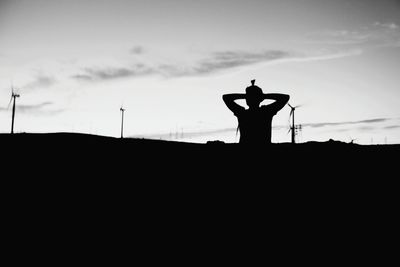 Silhouette man against sky during sunset