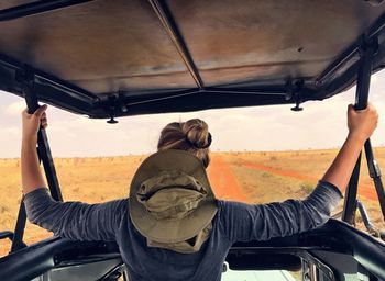 Rear view of woman in 4x4 in desert