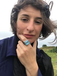 Portrait of woman with hand on chin wearing topaz ring