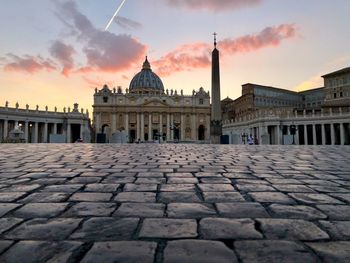 Footpath against church during sunset