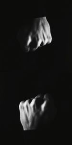 Close-up of hand against black background