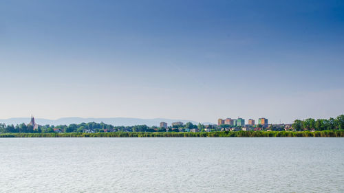 View of cityscape against clear blue sky