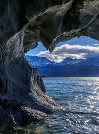 Scenic view of sea and mountains against sky