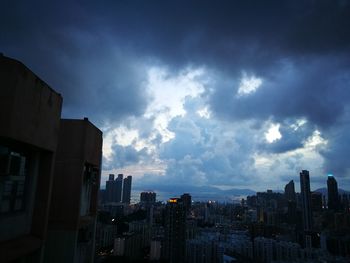 Cityscape against cloudy sky