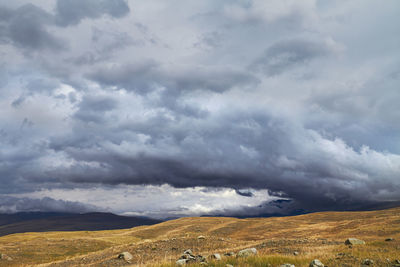 Scenic view of landscape against cloudy sky