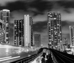 Blurred motion of train against buildings at night