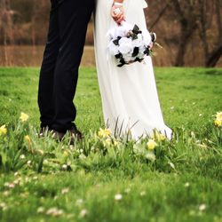 Rear view of mother and daughter on field