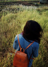 Woman standing on grassy field