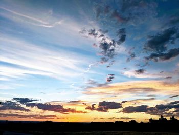 Silhouette landscape against sky during sunset