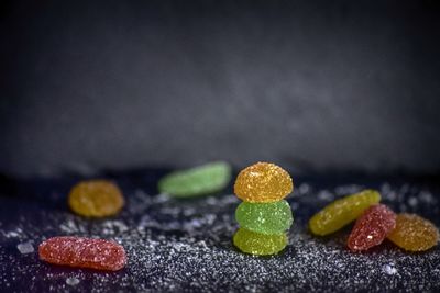 Close-up of candies on table against black background