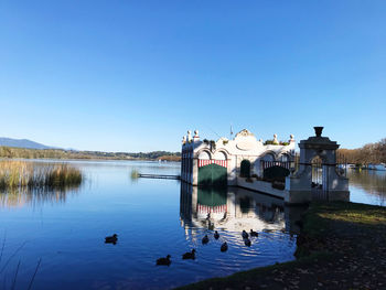 Scenic view of lake against clear blue sky