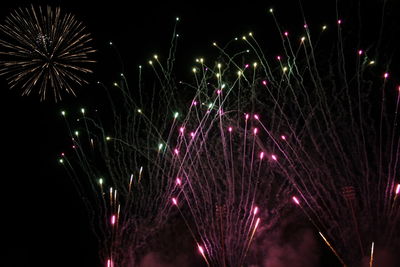 Low angle view of firework display at night