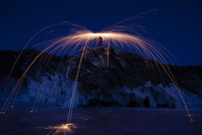 Fire at night over baikal lake