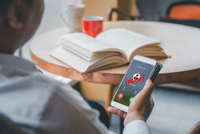 Midsection of man using mobile phone