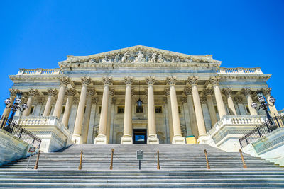 Low angle view of historical building against blue sky