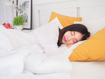 Young woman sleeping on bed