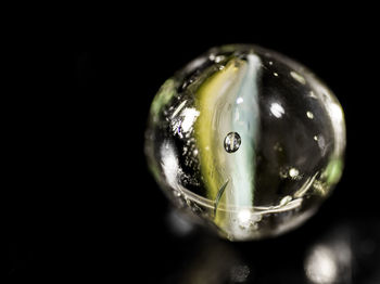 Close-up of crystal ball against black background