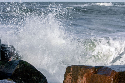 Waves splashing on rocks at shore