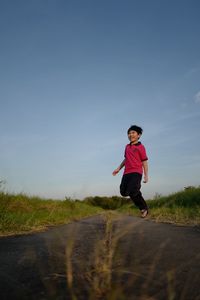 Full length of man running on road