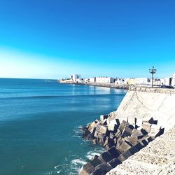 Scenic view of sea against clear blue sky