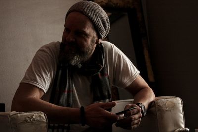 Man looking at camera while sitting on table