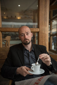 Portrait of man sitting at restaurant