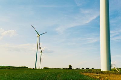 Windmill on field against sky