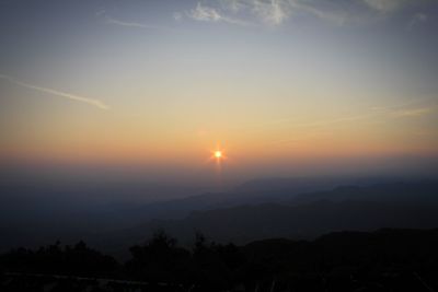 Scenic view of silhouette mountains against sky during sunset