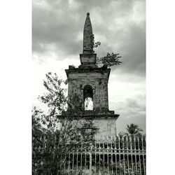 Low angle view of old building against cloudy sky